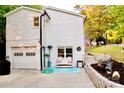White house with garage, cute patio with chairs, and well-maintained landscape at 27037 Tidal Way, Tega Cay, SC 29708