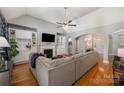 Open living room boasts hardwood floors, built-in bookshelves, a fireplace, and a vaulted ceiling at 2804 Pulaski Dr, Monroe, NC 28110