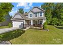 Charming two-story home with a well-maintained lawn and inviting front porch at 3615 Alamito Ln, Charlotte, NC 28214