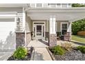 Charming front porch with stone accents, seating, and manicured landscaping at 3615 Alamito Ln, Charlotte, NC 28214