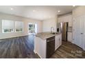 Bright kitchen featuring stainless steel appliances, granite countertops, and an open layout to the living area at 4217 Summit Woods Dr, Charlotte, NC 28216