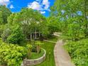 An aerial view shows a home with mature trees and manicured landscaping at 4523 Fox Brook Ln, Charlotte, NC 28211