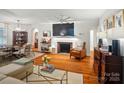 Open living space featuring a fireplace, hardwood floors, and stylish furnishings at 4647 General Pershing Dr, Charlotte, NC 28209