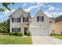 Charming two-story home featuring manicured lawn, and a two-car garage; perfect for Gathering living at 4711 Sunburst Ln, Charlotte, NC 28213
