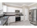 Bright kitchen with stainless steel appliances, granite countertops, and white cabinetry at 4711 Sunburst Ln, Charlotte, NC 28213