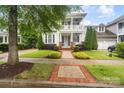 Charming two-story home featuring a welcoming porch and beautifully landscaped front yard at 5663 Morris Hunt Dr, Fort Mill, SC 29708