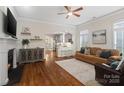 Open-concept living room with fireplace, seamlessly connecting to the modern kitchen at 5663 Morris Hunt Dr, Fort Mill, SC 29708