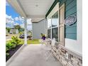 Cozy front porch with white columns, a table and chairs, and a 'Welcome to Our Home' sign at 6381 Trinity Crossing Cir, Kannapolis, NC 28081