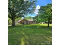 Attractive single-story brick home with mature trees, well-kept lawn, and welcoming front porch at 6573 Weldon Nw Cir # 22, Concord, NC 28027
