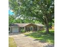 Single-story brick home with a well-maintained lawn and landscaping, garage, and driveway at 6573 Weldon Nw Cir # 22, Concord, NC 28027