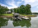 Picturesque waterfront home showcasing a private boat dock, lift, and stunning lake views at 7455 Ivey Dr, Sherrills Ford, NC 28673