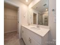 Stylish bathroom with double sinks, quartz countertops, and access to a walk-in closet at 820 Blue Canyon Dr, York, SC 29745