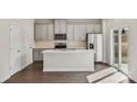 Well-lit kitchen features an island, stainless appliances, and gray cabinets at 820 Blue Canyon Dr, York, SC 29745