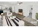 Bright, open concept living area with modern furnishings and seamless flow to the kitchen at 905 Brookdale St, Kannapolis, NC 28083