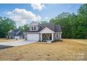 Beautifully designed home showcasing a landscaped front yard, an attached garage, and a welcoming entrance at 908 Westminster Dr, Statesville, NC 28677