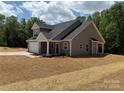Image of a new construction home showing the back of the property, freshly seeded yard and windows at 908 Westminster Dr, Statesville, NC 28677