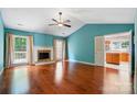 Spacious living room features hardwood floors, a fireplace, and views into kitchen and sunroom at 9927 Raddington Ln, Charlotte, NC 28269