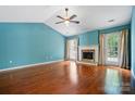 Bright living room features hardwood floors, fireplace, and french doors to deck at 9927 Raddington Ln, Charlotte, NC 28269