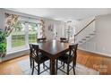 Light and airy dining room featuring hardwood floors and a large window with decorative curtains at 1014 Vandalia Dr, Charlotte, NC 28212