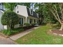 Charming home with dormer windows and a lush front yard with mature trees and landscaping at 1014 Vandalia Dr, Charlotte, NC 28212