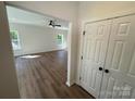 Bright living room with wood-look flooring, a ceiling fan, and natural light from the windows at 1563 Riverview Cir, Fort Lawn, SC 29714