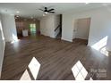 Open-concept living space with wood-look floors, recessed lighting, and easy access to the kitchen and stairs at 1563 Riverview Cir, Fort Lawn, SC 29714