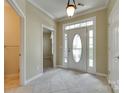 Bright foyer with neutral walls, tile flooring and an entrance door with sidelights at 1678 Onyx Rdg, Fort Mill, SC 29708