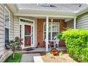 Inviting front porch with seating, brick accents, and mature landscaping at 1678 Onyx Rdg, Fort Mill, SC 29708