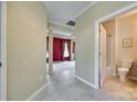 Hallway with tile flooring, leading to a living room and a half-bathroom at 1678 Onyx Rdg, Fort Mill, SC 29708