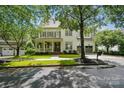 Charming two-story home featuring a covered porch, an expansive lawn, and a two-car garage at 201 Mills Ln, Fort Mill, SC 29708