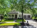 Charming two-story home with a covered front porch, a lush front lawn, and a two-car garage at 201 Mills Ln, Fort Mill, SC 29708
