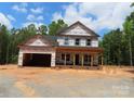New home featuring an open garage and brick foundation awaits its finishing touches at 2099 Cedar Rd, York, SC 29745