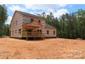 Spacious new home with a wooden porch is set amongst a partially wooded lot at 2099 Cedar Rd, York, SC 29745