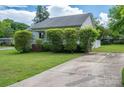 Well-maintained home featuring a convenient driveway and landscaping at 210 Park St, Bessemer City, NC 28016