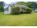 Charming home showcasing a well-maintained lawn and white picket fence at 210 Park St, Bessemer City, NC 28016