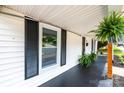 Inviting front porch featuring updated black paint, ferns, and white siding at 210 W 15Th St, Newton, NC 28658