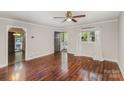 Bright living room featuring hardwood floors, a ceiling fan, neutral paint, and a window with natural light at 2109 Brewton Dr, Charlotte, NC 28206