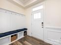 Welcoming entryway with storage bench, coat hooks, and stylish wood-look flooring at 2141 Bexar Trl, Matthews, NC 28105