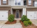 Inviting entryway with landscaped bushes, brick accents, and a modern front door at 2141 Bexar Trl, Matthews, NC 28105