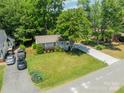 Aerial view of home featuring a long driveway, lush lawn, and mature trees providing ample shade at 21614 Colina Dr, Cornelius, NC 28031