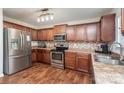 Spacious kitchen featuring stainless steel appliances, ample counter space, and wood floors at 2423 Dewey Creek Ln, Charlotte, NC 28216
