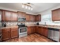 Well-appointed kitchen with stainless steel appliances, stylish backsplash, and wood floors at 2423 Dewey Creek Ln, Charlotte, NC 28216