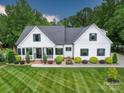 Charming traditional home featuring a well-manicured lawn and inviting front porch at 2608 Henry Baucom Rd, Monroe, NC 28110