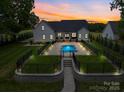Beautiful home with a fenced backyard, patio area, and a uniquely shaped pool at 2608 Henry Baucom Rd, Monroe, NC 28110