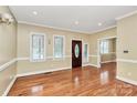 Bright living room with hardwood floors, large windows, and a warm, inviting atmosphere at 261 Melrose Sw Dr, Concord, NC 28025