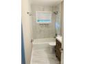 Modern bathroom with marble tile, a tub, shower, updated fixtures, and a new vanity at 2823 Albany Ln, Charlotte, NC 28205