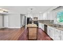 Spacious kitchen with an island, granite countertops, updated appliances, and hardwood floors at 2823 Albany Ln, Charlotte, NC 28205
