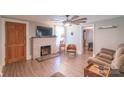 Comfortable living room with a brick fireplace and access to other rooms at 28782 Canton Rd # A, Albemarle, NC 28001