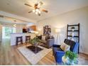Inviting living room with wood floors, seating, and an open layout flowing into the kitchen at 3055 Golden Dale Ln # 104, Charlotte, NC 28262