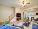 Bright living room with wood floors, open layout, staircase, and stylish furnishings at 3055 Golden Dale Ln # 104, Charlotte, NC 28262